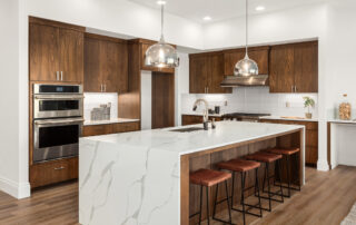 Kitchen,In,New,Luxury,Home,With,Quartz,Waterfall,Island,,Hardwood